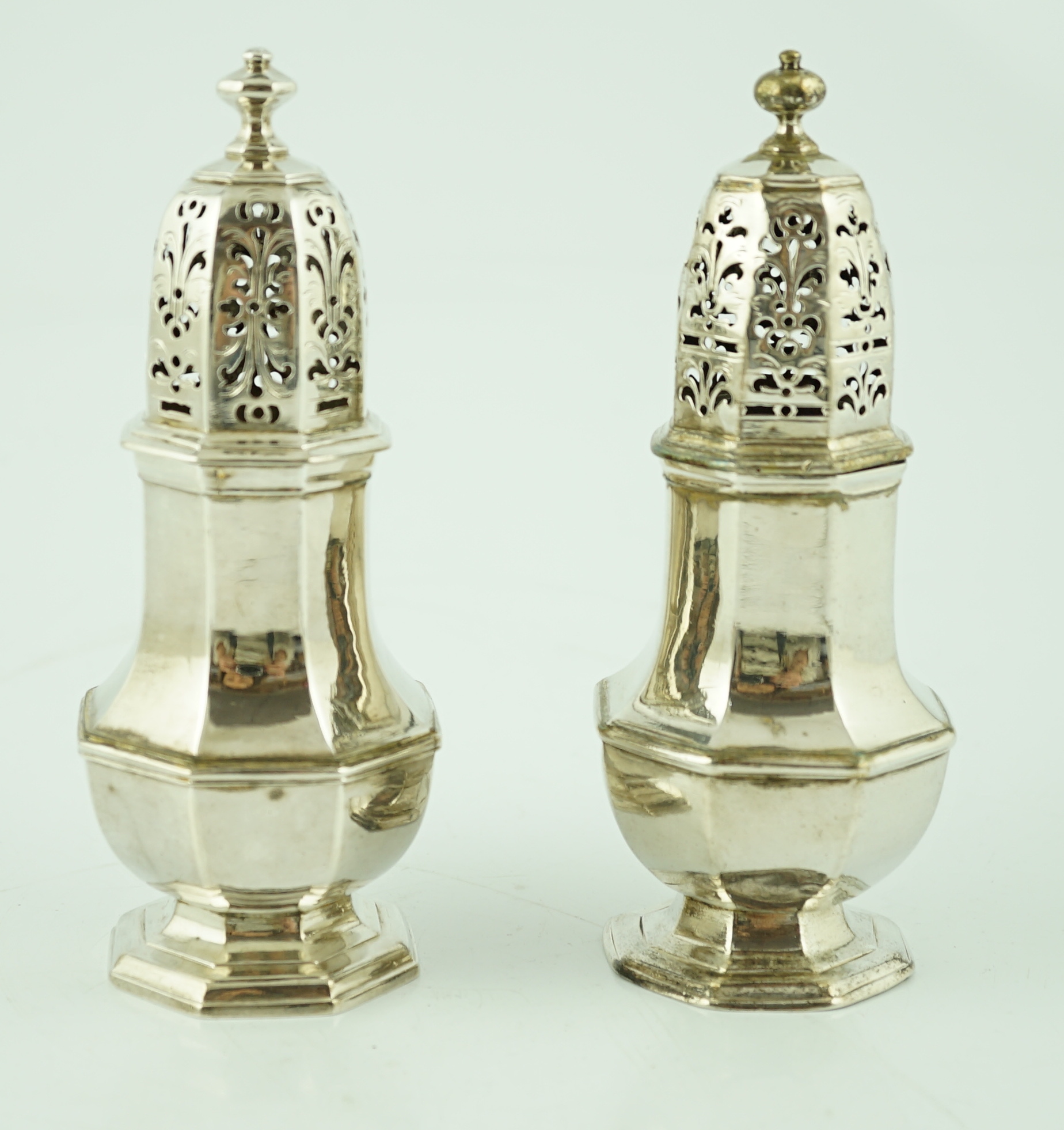 A near pair of George I/George II silver octagonal baluster casters